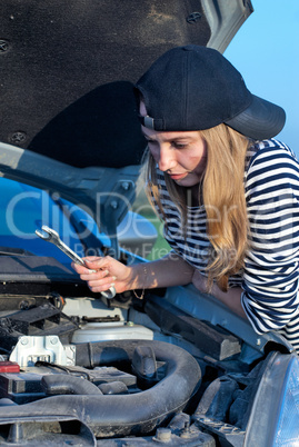 Young Blond Woman With Her Broken Car