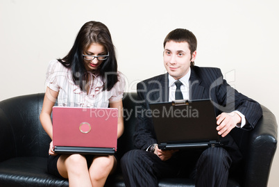 Businessmen with computers on sofa