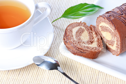 Swiss roll with condensed milk cream and a cup of tea