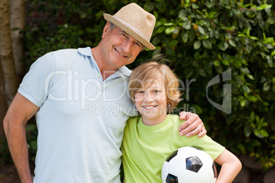 Grandfather and his grandson looking at the camera