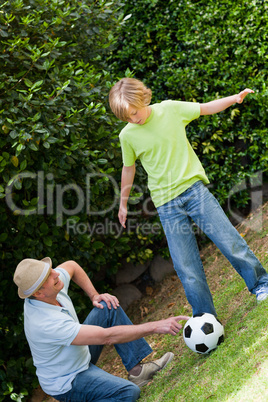 Grandfather and his grandson playing football