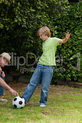 Grandfather and his grandson playing football