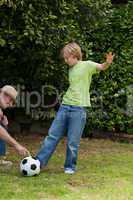 Grandfather and his grandson playing football