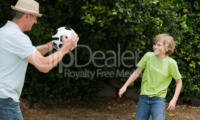 Grandfather and his grandson playing football