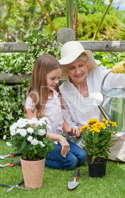 Grandmother with her granddaughter working in the garden