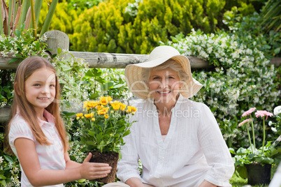 Grandmother with her granddaughter working in the garden