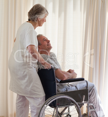 Retired couple looking out the window