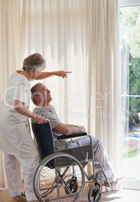 Retired couple looking out the window
