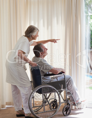 Retired couple looking out the window