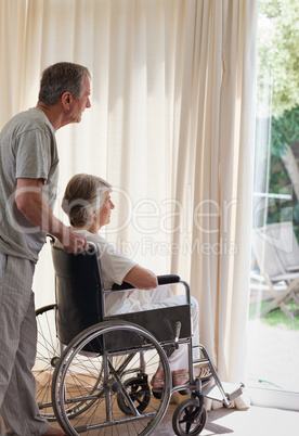 Retired couple looking out the window