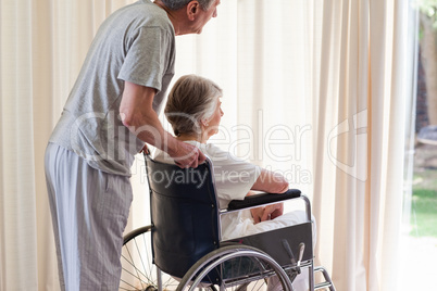 Retired couple looking out the window