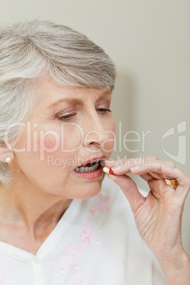 Sick senior woman taking her pills