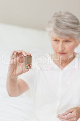 Sick senior woman taking her pills