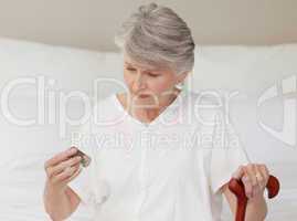 Sick senior woman taking her pills