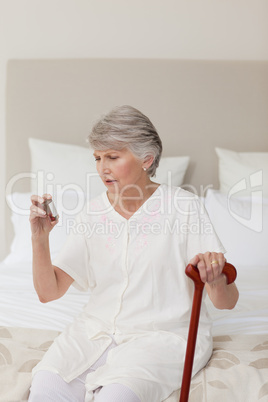 Sick senior woman taking her pills