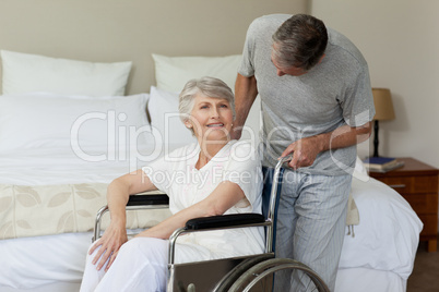 Retired woman in her wheelchair with her husband