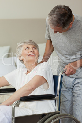 Retired woman in her wheelchair with her husband