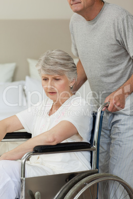 Retired woman in her wheelchair with her husband