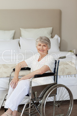 Smiling senior woman in her wheelchair