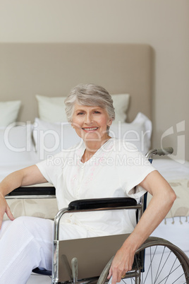 Smiling senior woman in her wheelchair