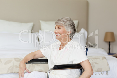 Smiling senior woman in her wheelchair