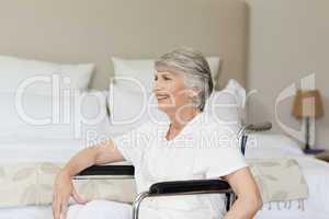 Smiling senior woman in her wheelchair