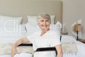 Smiling senior woman in her wheelchair