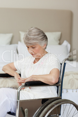 Senior woman asleep in her wheelchair at home