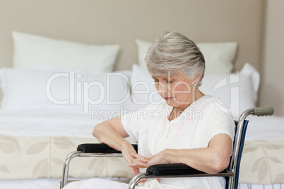 Senior woman asleep in her wheelchair at home