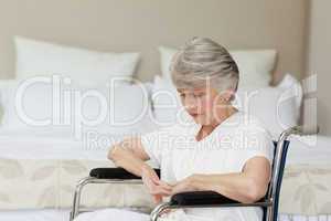 Senior woman asleep in her wheelchair at home