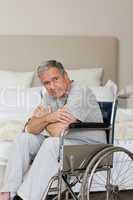 Thoughtful senior man in his wheelchair