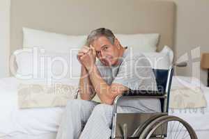 Thoughtful senior man in his wheelchair