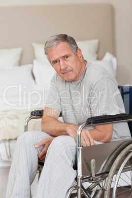 Thoughtful senior man in his wheelchair