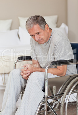 Thoughtful senior man in his wheelchair