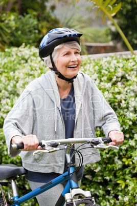 Mature woman walking with her mountain bike