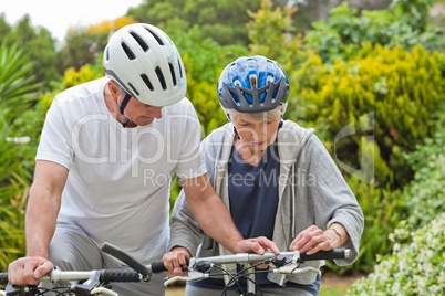 Mature couple mountain biking outside