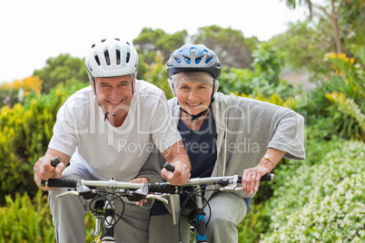 Mature couple mountain biking outside