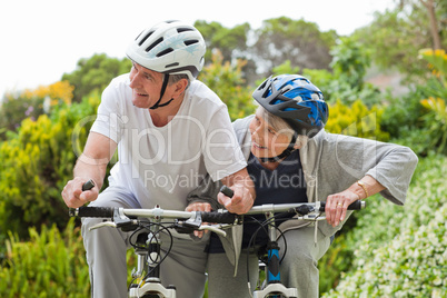 Mature couple mountain biking outside