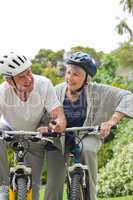 Mature couple mountain biking outside