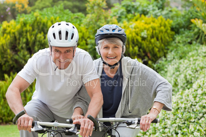 Mature couple mountain biking outside