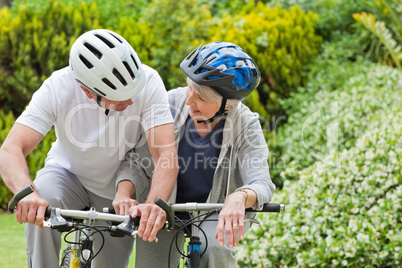 Mature couple mountain biking outside