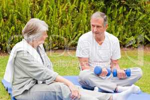 Mature couple doing their exercises in the garden