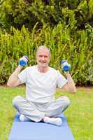 Retired man doing his exercises in the garden