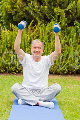 Retired man doing his exercises in the garden