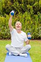 Retired man doing his exercises in the garden