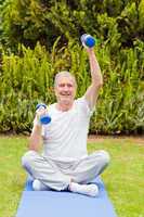 Retired man doing his exercises in the garden