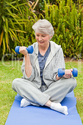 Retired woman doing her exercises in the garden