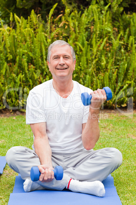 Retired man doing his exercises in the garden