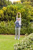 Retired  woman doing her streches in the garden