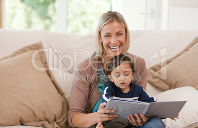 Mother looking at a book with her son